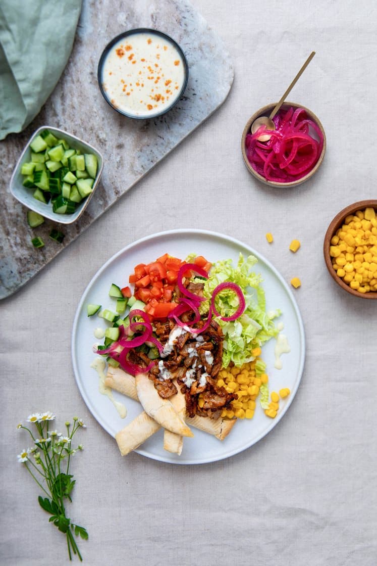 Grillet gyros med kinakål, mais og syltet rødløk, servert med sprø brødpinner og yoghurtdressing
