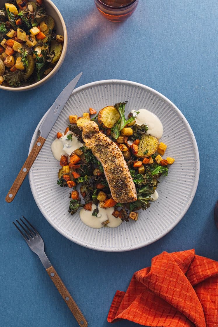 Krydderbakt laksefilet med grønnkålpoteter, stekte rotgrønnsaker og kremet pepperrotsaus